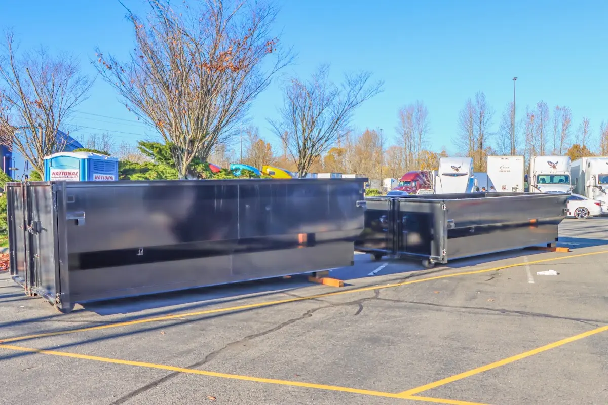 Professional dumpster rental service with roll-off container on residential driveway in Willistown